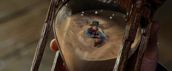 Movie still from “Night at the Museum: Battle of the Smithsonian” (2009), directed by Shawn Levy – A man in a hat is sitting in the sand; Extreme Close Up shot, High angle