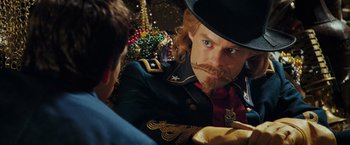 Movie still from “Night at the Museum: Battle of the Smithsonian” (2009), directed by Shawn Levy – A man in a military uniform and a top hat; Close Up shot, Over the shoulder angle