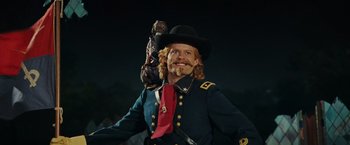 Movie still from “Night at the Museum: Battle of the Smithsonian” (2009), directed by Shawn Levy – A man in a military uniform with a monkey on his shoulder; Medium shot, Low angle