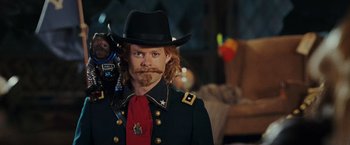 Movie still from “Night at the Museum: Battle of the Smithsonian” (2009), directed by Shawn Levy – A man in a cowboy outfit with a stuffed monkey; Close Up shot, Over the shoulder angle