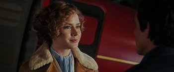 Movie still from “Night at the Museum: Battle of the Smithsonian” (2009), directed by Shawn Levy – A person sitting in front of a train; Close Up shot, Over the shoulder angle