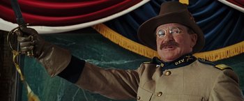 Movie still from “Night at the Museum: Battle of the Smithsonian” (2009), directed by Shawn Levy – A man dressed as an officer waves to the crowd; Close Up shot, Low angle