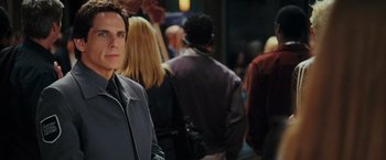 Movie still from “Night at the Museum: Battle of the Smithsonian” (2009), directed by Shawn Levy – A man standing in a crowd of other people; Close Up shot, Over the shoulder angle