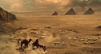 Movie still from “Night at the Museum: Secret of the Tomb” (2014), directed by Shawn Levy – A group of people riding horses in the desert; Extreme Wide shot, Low angle