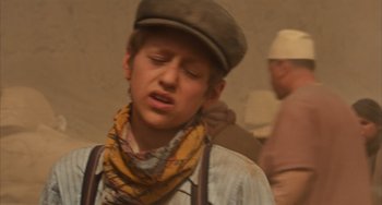 Movie still from “Night at the Museum: Secret of the Tomb” (2014), directed by Shawn Levy – A young man wearing a hat and a scarf; Close Up shot, High angle
