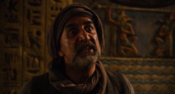 Movie still from “Night at the Museum: Secret of the Tomb” (2014), directed by Shawn Levy – A man with a beard and a turban on; Close Up shot, Over the shoulder angle