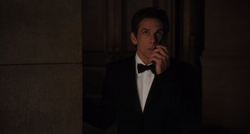 Movie still from “Night at the Museum: Secret of the Tomb” (2014), directed by Shawn Levy – A man in a tuxedo standing next to a wall; Medium shot, Over the shoulder angle