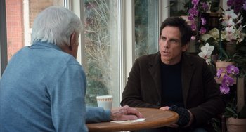 Movie still from “Night at the Museum: Secret of the Tomb” (2014), directed by Shawn Levy – A man sitting at a table talking to another man in front of a window; Medium shot, Over the shoulder angle