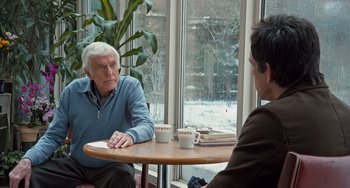 Movie still from “Night at the Museum: Secret of the Tomb” (2014), directed by Shawn Levy – A man sitting at a table in front of another man; Medium shot, Over the shoulder angle