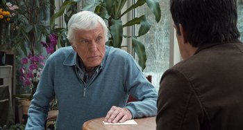 Movie still from “Night at the Museum: Secret of the Tomb” (2014), directed by Shawn Levy – An older man sitting at a table with a younger man; Close Up shot, Over the shoulder angle