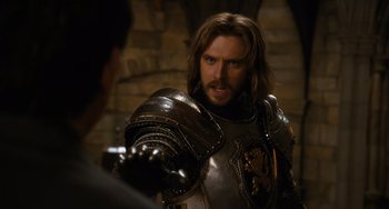 Movie still from “Night at the Museum: Secret of the Tomb” (2014), directed by Shawn Levy – A man wearing a suit of armor and holding a sword in his hand; Close Up shot, Over the shoulder angle