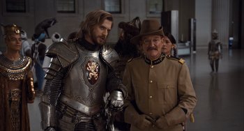 Movie still from “Night at the Museum: Secret of the Tomb” (2014), directed by Shawn Levy – Two men in medieval garb standing next to each other; Medium shot, Over the shoulder angle