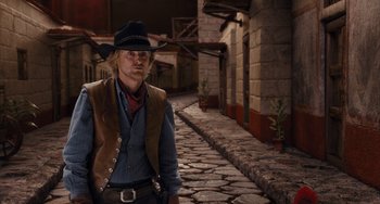 Movie still from “Night at the Museum: Secret of the Tomb” (2014), directed by Shawn Levy – A man wearing a cowboy hat standing on a street; Medium shot, Over the shoulder angle