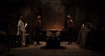Movie still from “Night at the Museum: Secret of the Tomb” (2014), directed by Shawn Levy – A couple of men standing in front of an open fire; Wide shot, High angle