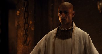 Movie still from “Night at the Museum: Secret of the Tomb” (2014), directed by Shawn Levy – A man wearing a white shirt and a neck piece; Close Up shot, Over the shoulder angle