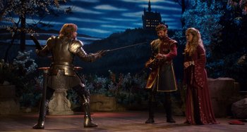 Movie still from “Night at the Museum: Secret of the Tomb” (2014), directed by Shawn Levy – Two men and a woman in medieval garb on a stage; Wide shot, Over the shoulder angle