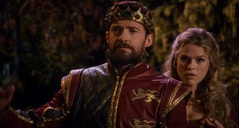 Movie still from “Night at the Museum: Secret of the Tomb” (2014), directed by Shawn Levy – A man wearing a red and gold outfit and a crown; Close Up shot, Over the shoulder angle