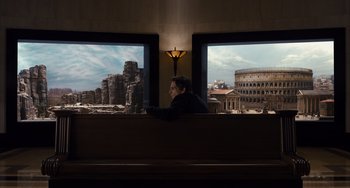 Movie still from “Night at the Museum: Secret of the Tomb” (2014), directed by Shawn Levy – A man sitting in front of two large windows; Wide shot, Over the shoulder angle