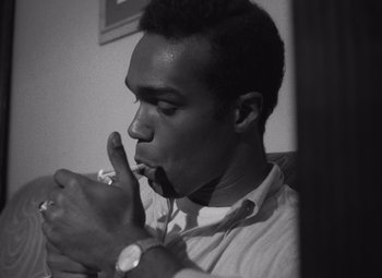 Movie still from “Night of the Living Dead” (1968), directed by George A. Romero – A black and white photo of a man brushing his teeth; Close Up shot, Low angle