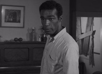 Movie still from “Night of the Living Dead” (1968), directed by George A. Romero – A black and white photo of a man in a shirt and tie; Close Up shot, High angle