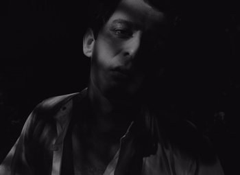 Movie still from “Night of the Living Dead” (1968), directed by George A. Romero – A black and white photo of a man with his head turned to the side; Close Up shot, Low angle