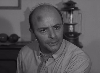 Movie still from “Night of the Living Dead” (1968), directed by George A. Romero – Black and white photograph of a man in a dress shirt and tie; Close Up shot, Low angle