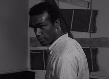 Movie still from “Night of the Living Dead” (1968), directed by George A. Romero – A black and white photo of a man in a shirt and tie; Close Up shot, Low angle