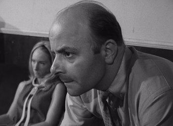 Movie still from “Night of the Living Dead” (1968), directed by George A. Romero – A black and white photo of a man and a woman; Close Up shot, Low angle