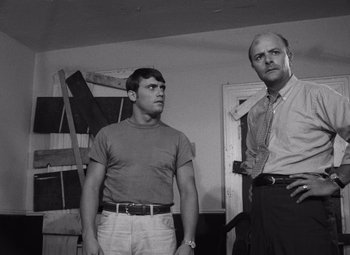 Movie still from “Night of the Living Dead” (1968), directed by George A. Romero – Two men standing next to each other in a room; Medium shot, Low angle