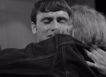 Movie still from “Night of the Living Dead” (1968), directed by George A. Romero – A man and a woman hugging each other in a black and white photo; Close Up shot, Over the shoulder angle