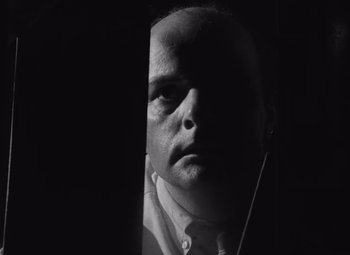 Movie still from “Night of the Living Dead” (1968), directed by George A. Romero – A black and white photo of a man's face; Close Up shot, Low angle