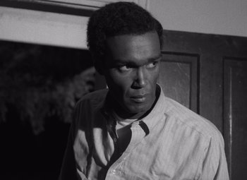 Movie still from “Night of the Living Dead” (1968), directed by George A. Romero – A black and white photo of a man wearing a shirt and tie; Close Up shot, High angle