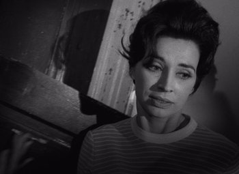 Movie still from “Night of the Living Dead” (1968), directed by George A. Romero – A black - and - white photo of a woman in a striped shirt; Close Up shot, Over the shoulder angle