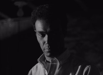 Movie still from “Night of the Living Dead” (1968), directed by George A. Romero – A black and white photo of a man in a white shirt; Close Up shot, Low angle