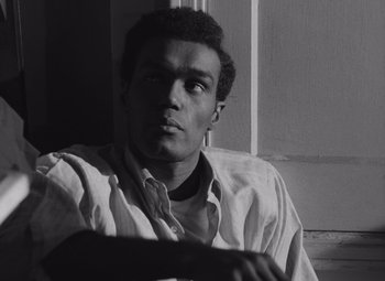 Movie still from “Night of the Living Dead” (1968), directed by George A. Romero – A black and white photo of a man looking at the camera; Close Up shot, Low angle