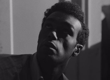 Movie still from “Night of the Living Dead” (1968), directed by George A. Romero – A black and white photo of a man looking up at the sky; Close Up shot, Low angle