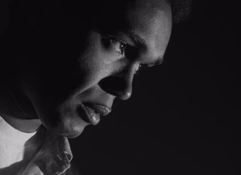 Movie still from “Night of the Living Dead” (1968), directed by George A. Romero – A black and white photo of a man's face; Extreme Close Up shot, Low angle
