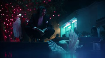 Movie still from “Euphoria” (2019), created by Sam Levinson – A man in a suit sitting on the ground; Medium shot, Low angle