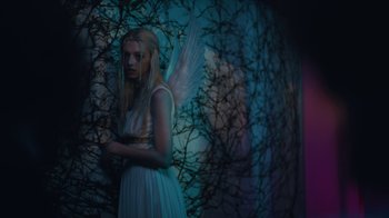 Movie still from “Euphoria” (2019), created by Sam Levinson – A woman in a white dress with a white angel wings; Medium shot, Low angle