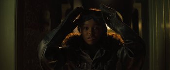Movie still from “Nightbooks” (2021), directed by David Yarovesky – A young child wearing goggles and a jacket; Close Up shot, Low angle