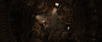 Movie still from “Nightbooks” (2021), directed by David Yarovesky – The ceiling of a building with a spiral staircase; Extreme Wide shot, Overhead angle