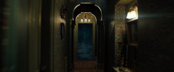 Movie still from “Nightbooks” (2021), directed by David Yarovesky – A dark hallway with a clock on the wall; Wide shot, High angle
