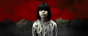 Movie still from “Nightbooks” (2021), directed by David Yarovesky – A young boy in a black and white t - shirt; Medium shot, Overhead angle