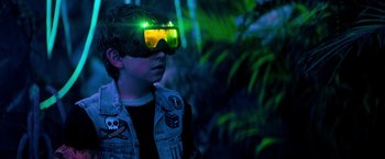 Movie still from “Nightbooks” (2021), directed by David Yarovesky – A young boy wearing a pair of green goggles; Close Up shot, Over the shoulder angle