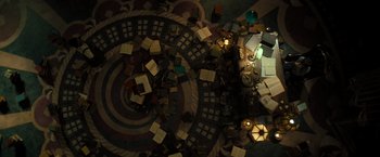 Movie still from “Nightbooks” (2021), directed by David Yarovesky – An overhead view of a room filled with furniture; Extreme Wide shot, Overhead angle