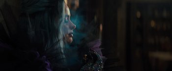 Movie still from “Nightbooks” (2021), directed by David Yarovesky – A woman with long white hair is looking up; Close Up shot, Over the shoulder angle