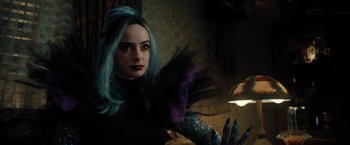 Movie still from “Nightbooks” (2021), directed by David Yarovesky – A woman with blue hair is posing for a picture; Close Up shot, Over the shoulder angle