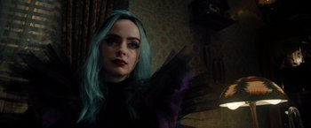 Movie still from “Nightbooks” (2021), directed by David Yarovesky – A woman with blue and purple hair is posing for a picture; Close Up shot, Over the shoulder angle