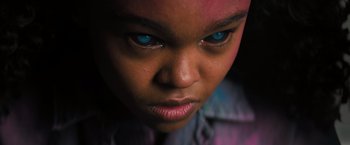 Movie still from “Nightbooks” (2021), directed by David Yarovesky – A person's face with blue eyes; Extreme Close Up shot, Low angle