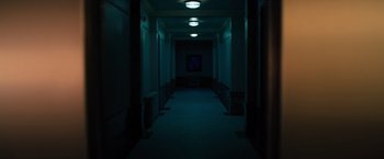 Movie still from “Nightbooks” (2021), directed by David Yarovesky – A dark hallway with a painting on the wall; Extreme Wide shot, Low angle